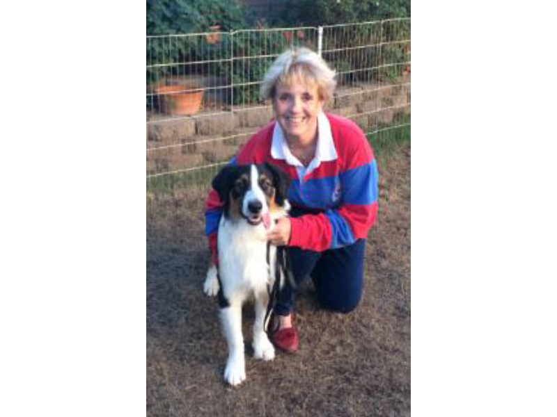 Woman kneeling with her adorable dog.