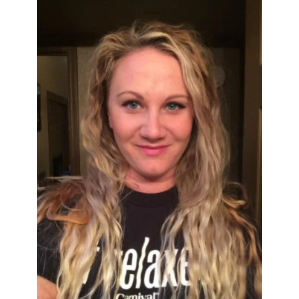 Here's an alt tag for the image: Blonde woman smiling, wearing black shirt.