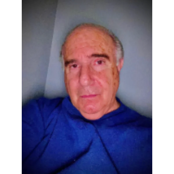 Here's an alt tag for the image: Portrait of an older man in blue.