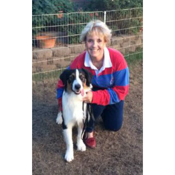 Woman kneeling with her adorable dog.